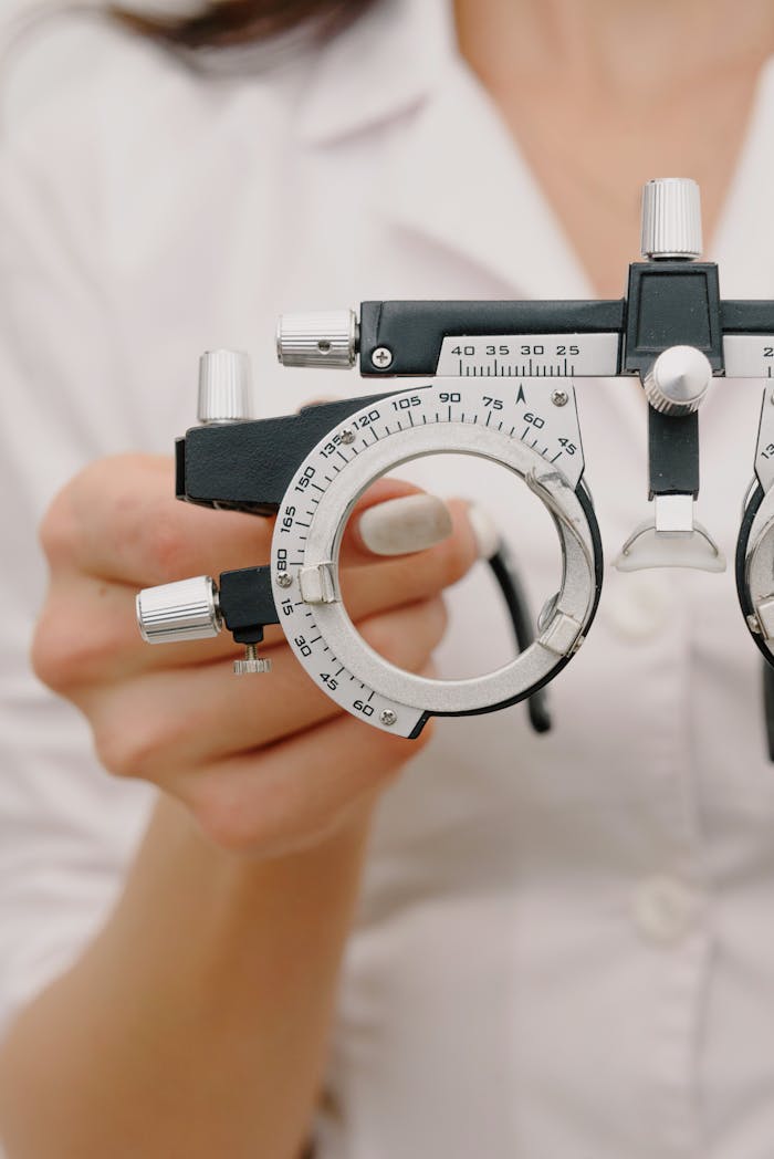 Close-up of an optometrist using diagnostic eye care equipment.